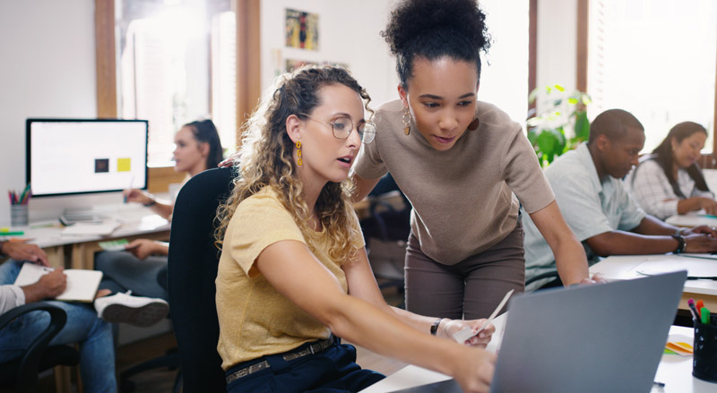 two-professional-it-workers-looking-at-a-computer
